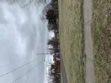 Color photo of an empty, grassy lot