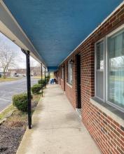 Color image of walkway in front of hotel rooms