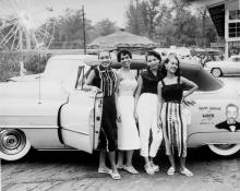 Four women in front of Hoppy Adams' Cadillac convertible at Carr's Beach Annapolis